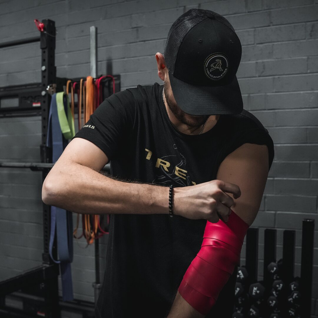 Athlete wrapping arm in Rocket Wrap